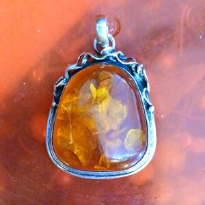 Elegant Amber Pendant with Sterling Silver Detailing